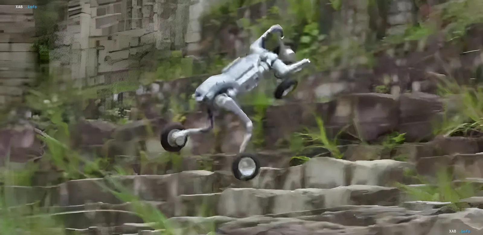 Unitree AS2-W in action: overcoming complex terrain Unitree AS2-W robot demonstrates dynamic movement across rough terrain, navigating stone steps using its wheeled-legged platform.