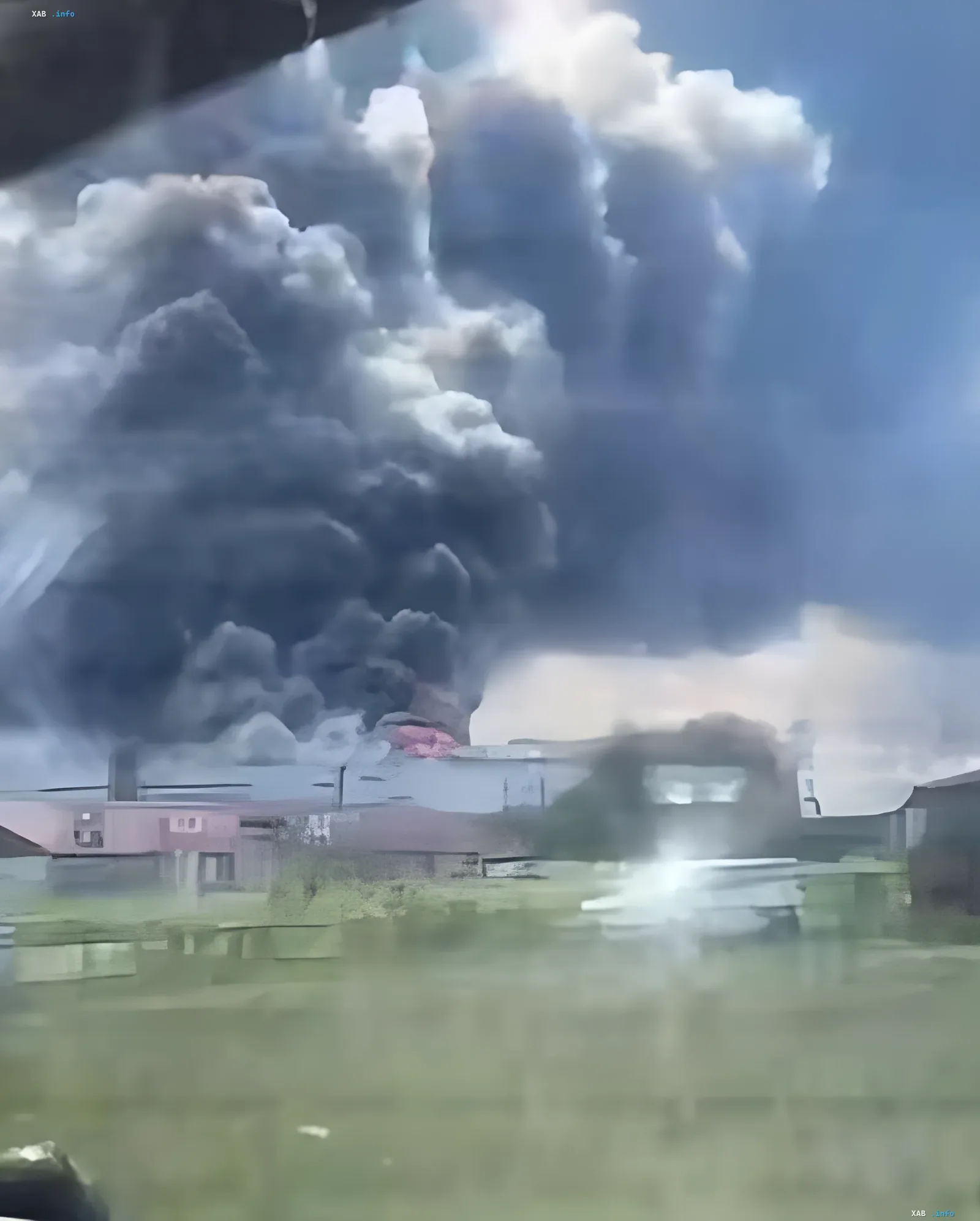 Thick black smoke from fire at Wildberries warehouse near Samara after drone strike, viewed from road