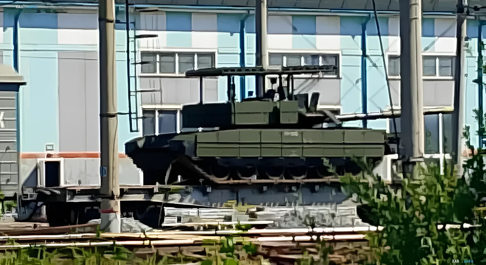 Modernized Russian T-80BVM tank equipped with a protective 'mangal' cage for defense against drones
