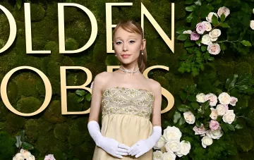 Ariana Grande on the Golden Globes red carpet in an elegant gown and white gloves — her last public appearance before taking a hiatus