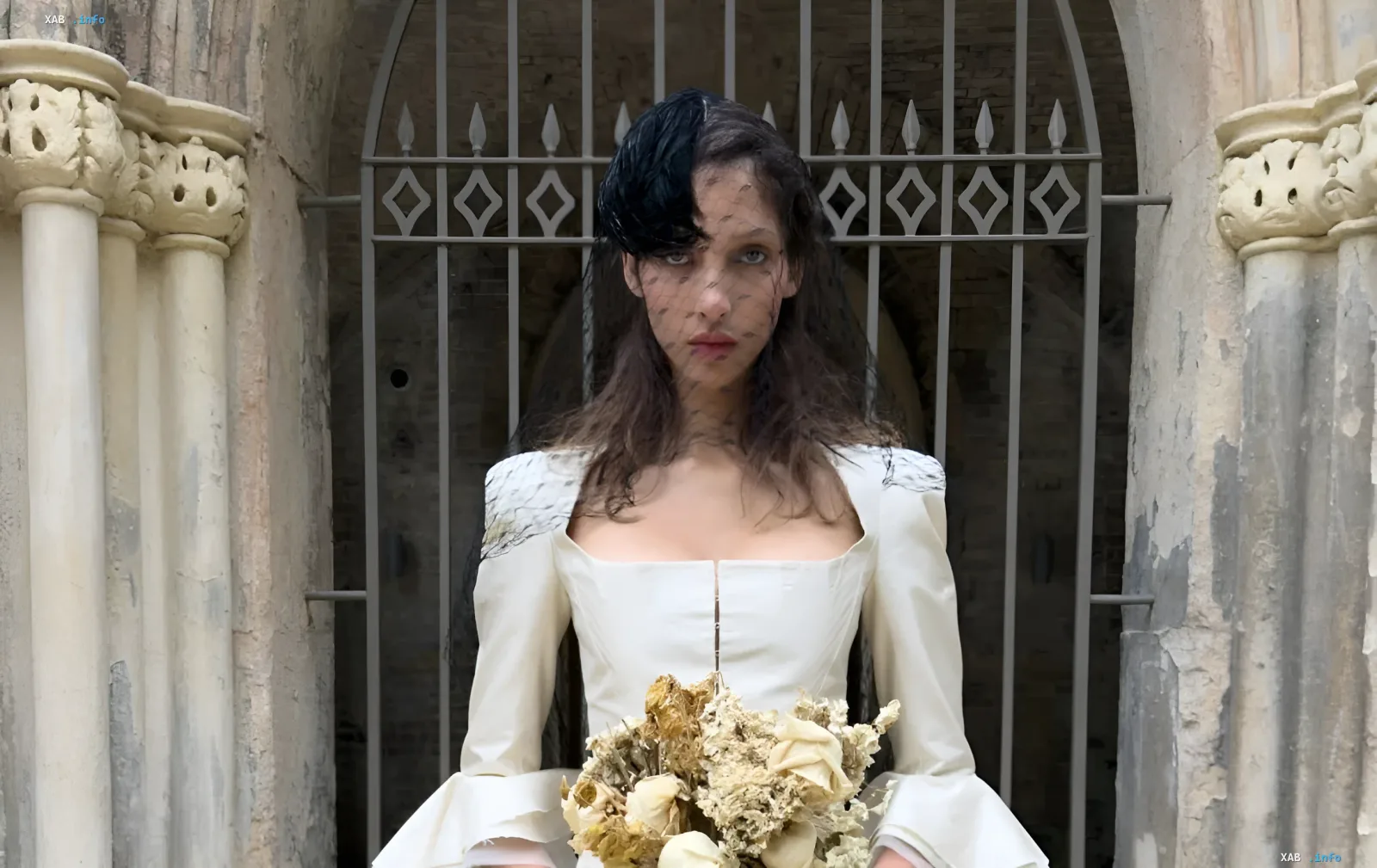 Model in Dilara Findikoglu wedding dress with gothic elements against old architecture