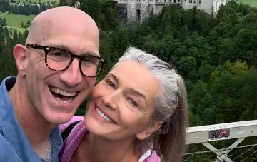 Happy couple in mature age against a castle backdrop — illustration for article on July celebrity weddings