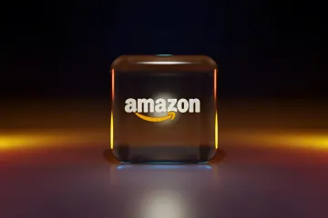 Amazon-Logo auf einem beleuchteten Glaswürfel, das den Meilenstein von 3 Billionen Dollar Marktkapitalisierung symbolisiert, angetrieben vom KI-Boom