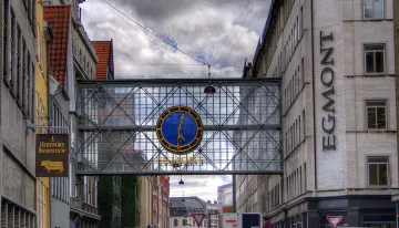 Egmont Group building with distinctive glass bridge and clock, symbolizing reliable protection for banks against money laundering