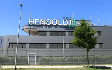 Building with Hensoldt logo — new engineering center established on the former Bosch plant site, symbolizing the mass transition of automotive specialists to defense industry