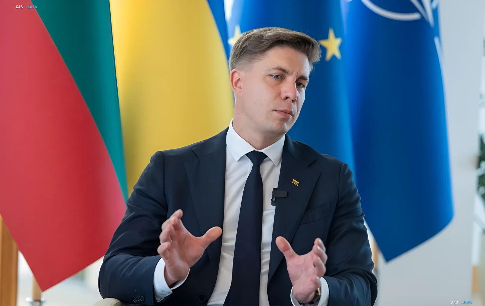 Litauischer Bildungsminister spricht vor Flaggen Litauens, der Ukraine und der EU über Schulreformen und Ablehnung der „imperialen Ideologie“