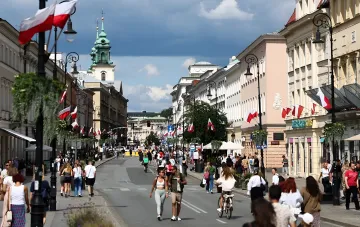 Warsaw street adorned with Polish flags, symbolizing Poland's stance on Ukraine's EU accession