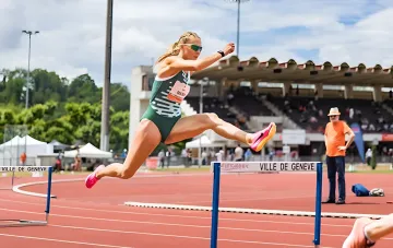 Victoria Tkachuk mid-hurdle jump at Geneva stadium, showcasing technique ahead of European Championships 2026