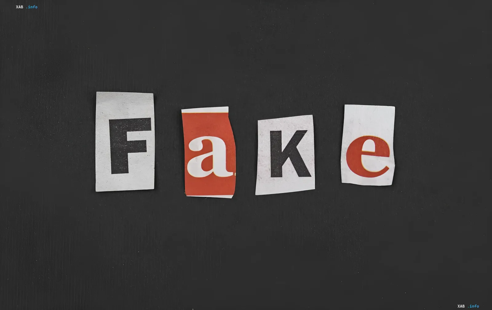 Слово 'FAKE' из вырезанных букв на черном фоне, символизирующее фейковые новости и ИИ-манипуляции с фотографиями погибших украинцев