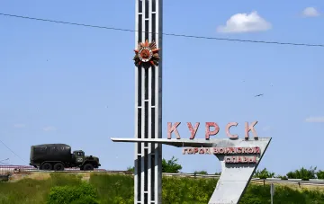 Russian military truck with Z marking passes by the 'Kursk — City of Military Glory' sign — symbol of Russian propaganda attempting to rewrite the history of the Battle of Kursk