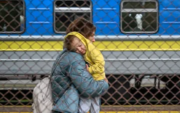 Мати з дитиною біля потягу через паркан — символ міграції та контрасту між реальністю та ксенофобськими наративами в польському інфополі