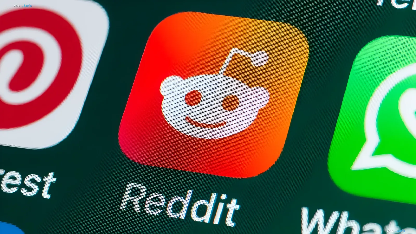 Reddit logo on a smartphone screen, symbolizing upcoming changes: karma removal and AI moderation rollout