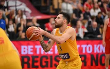 Ukraine basketball player in yellow jersey with number 5 passes the ball during a World Cup 2027 qualifier match