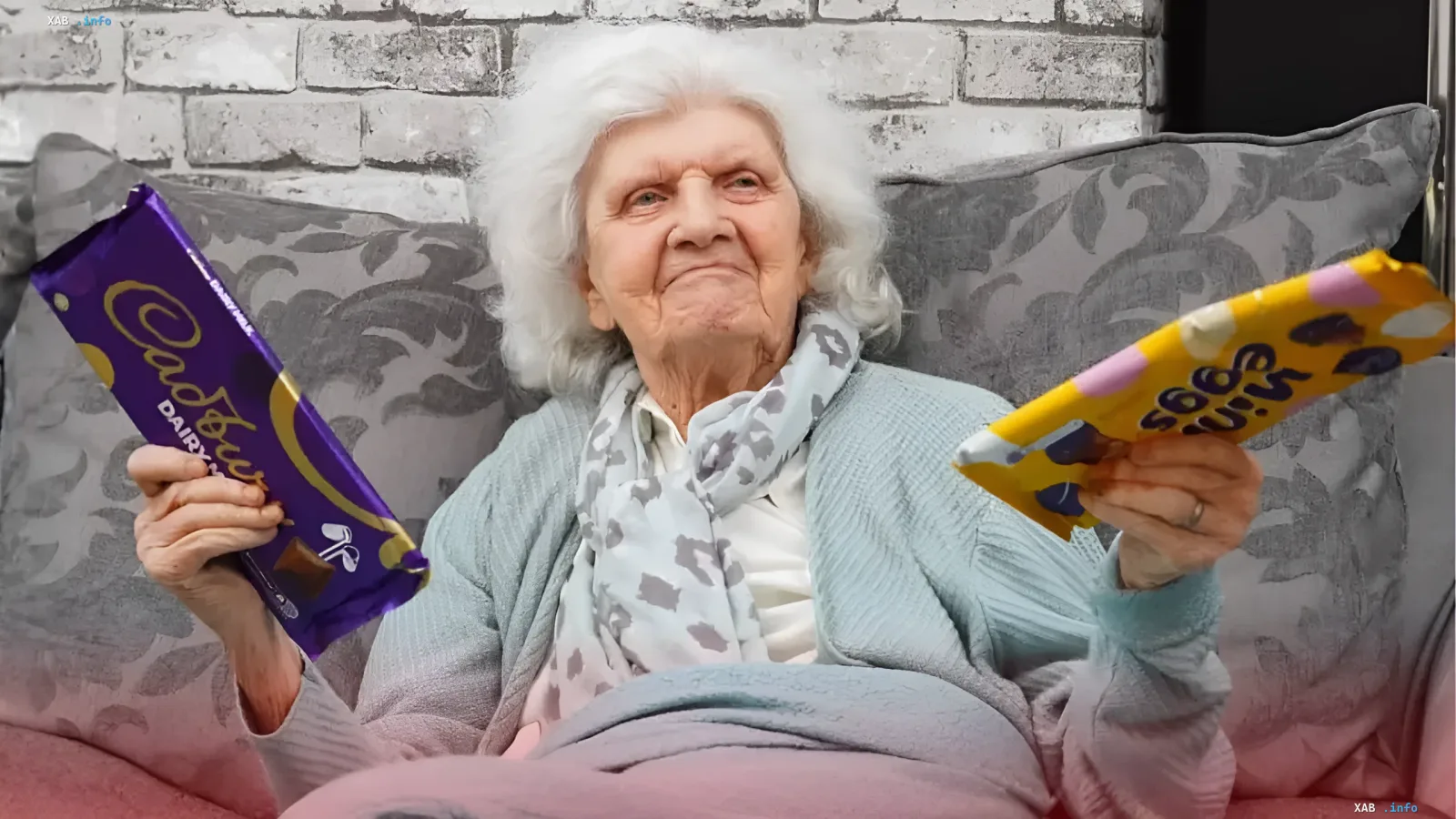 106-year-old Briton Edith Hill holds Cadbury and Milka chocolate bars, smiling — her secret to longevity and love for sweets