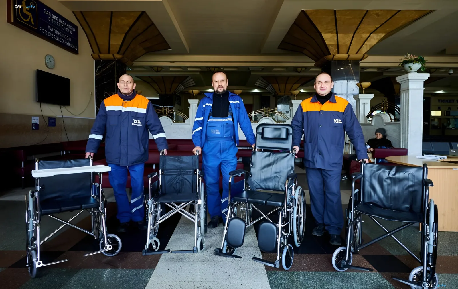 Ukrzaliznytsia staff with wheelchairs in the waiting room for passengers with disabilities