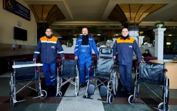 Ukrzaliznytsia staff with wheelchairs in the waiting room for passengers with disabilities