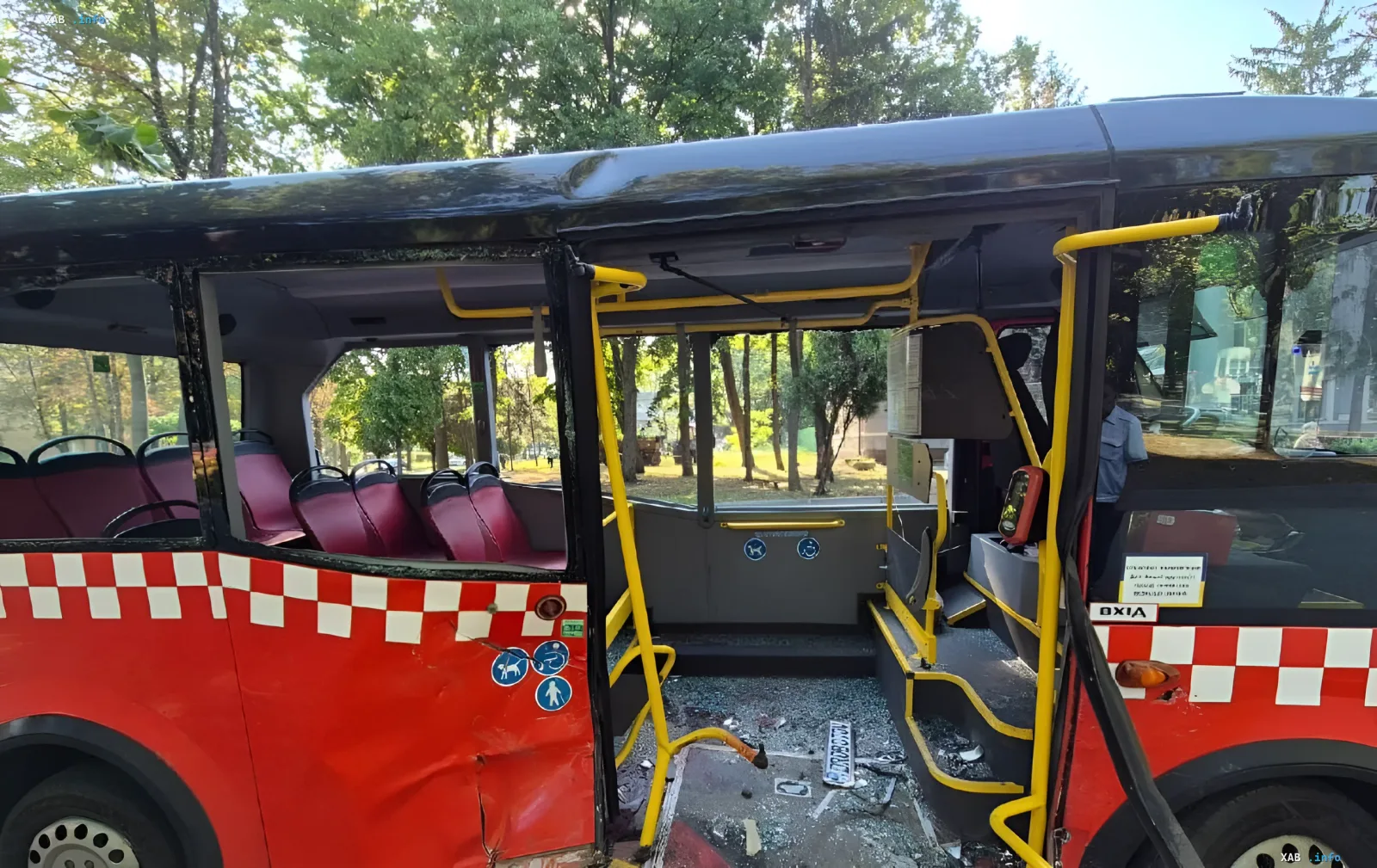 Damaged bus after mass accident in Kharkiv: glass shards on the floor, dented side, and empty seats