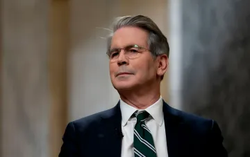 Stephen Bessent in a business suit discusses potential ceasefire timelines between the US and Iran