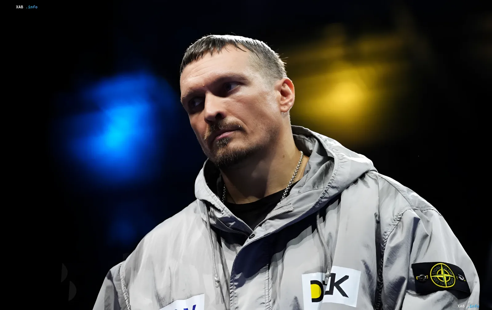 Александр Усик в серой куртке с логотипом Stone Island, задумчивый взгляд перед боем с Уайлдером