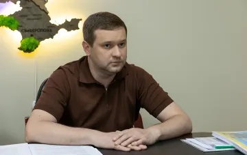 Deputy General Prosecutor of Ukraine Maxim Krym at his desk discussing the crisis of powers and protection of state interests