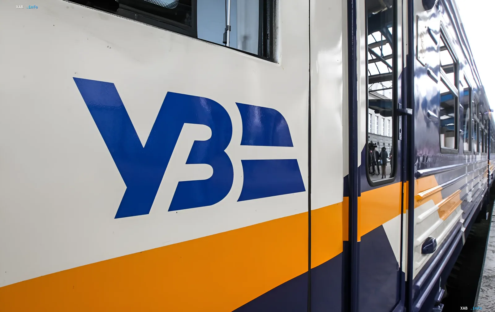 Passenger train with UZ logo (Ukrainian Railways) at station after attack: locomotive damaged, passengers evacuated without casualties