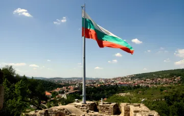 Bulgarian flag against a city backdrop, illustrating the drone incident over Bulgarian territory, which Sofia links to the Ukrainian 'Maya' decoy