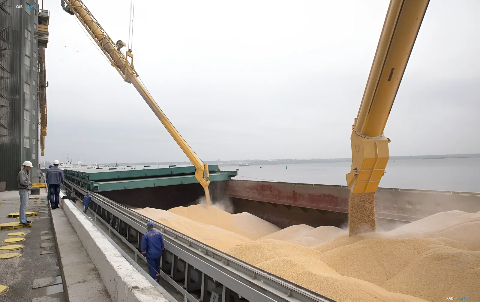 Loading grain into a ship's hold at a Ukrainian port: illustrating export challenges due to corridor blockade and Russian attacks