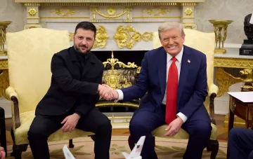 Ukrainian President Zelenskyy and US President Trump shake hands in the Oval Office, symbolizing alliance in the context of military protection for Ukraine