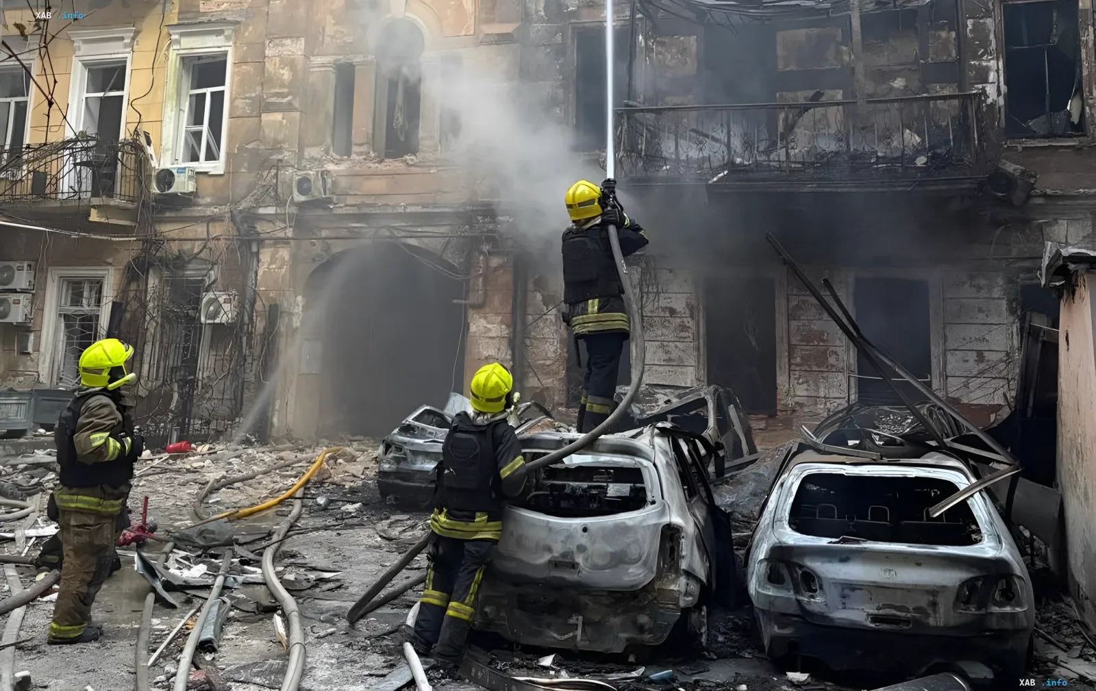 Firefighters extinguish the aftermath of a night attack on Odesa: burnt cars and a destroyed building