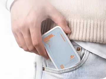 Compact Pandaer PTC16 charger in jeans pocket, showcasing its portability and convenience for travel