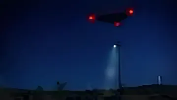 Triangular flying object with red lights over a night landscape, illustration for the article about Pentagon's declassified archives on UFOs in Oman and Afghanistan
