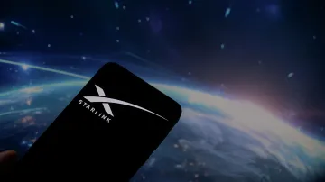 Smartphone with Starlink logo against Earth from space — symbolizing SpaceX’s plans to capture the mobile market, which T-Mobile’s CEO called exaggerated