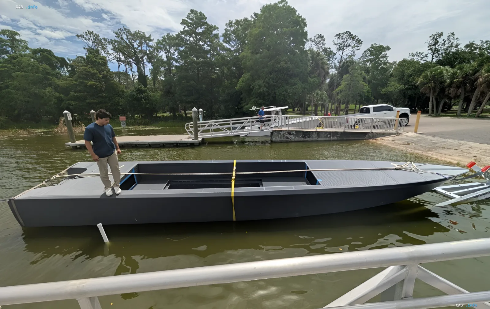 Unmanned boat TF-179 by Haddy, printed using giant 3D printing, on water with a person nearby