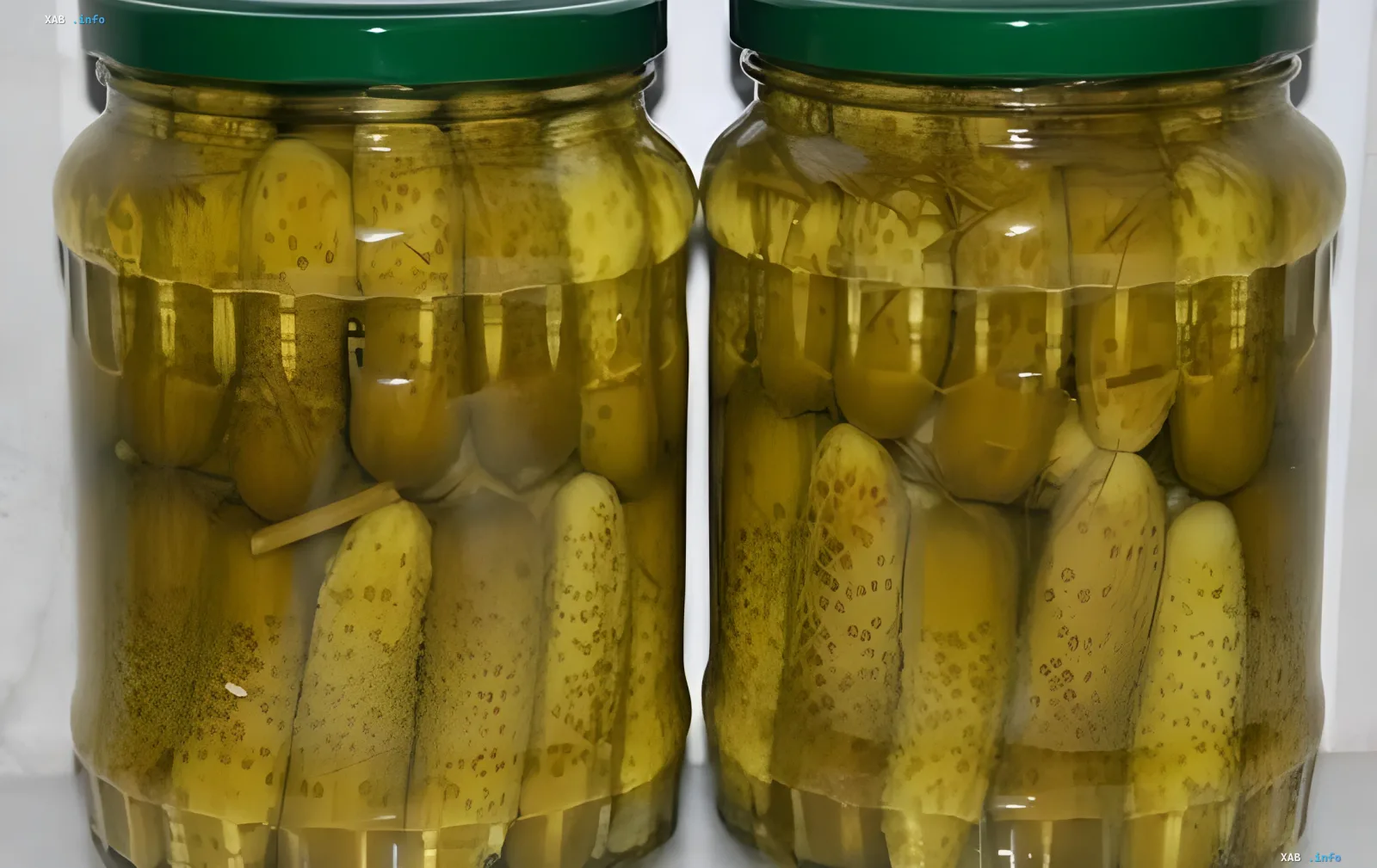 Two jars of pickled cucumbers showcasing perfect crunch and clear brine — the result of home canning using the 2026 recipe