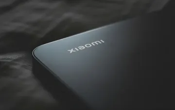 Xiaomi logo on smartphone body, symbolizing innovation ahead of Mix Fold 5 and HyperOS 4 launch