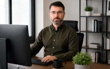 Cybersicherheitsspezialist am Schreibtisch mit Computer, der die Arbeit des Teams des ukrainischen Startups VulnWatch im Jahr 2026 symbolisiert