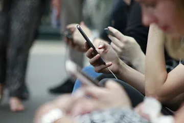 People using smartphones while waiting for internet restoration after an outage in Kamchatka