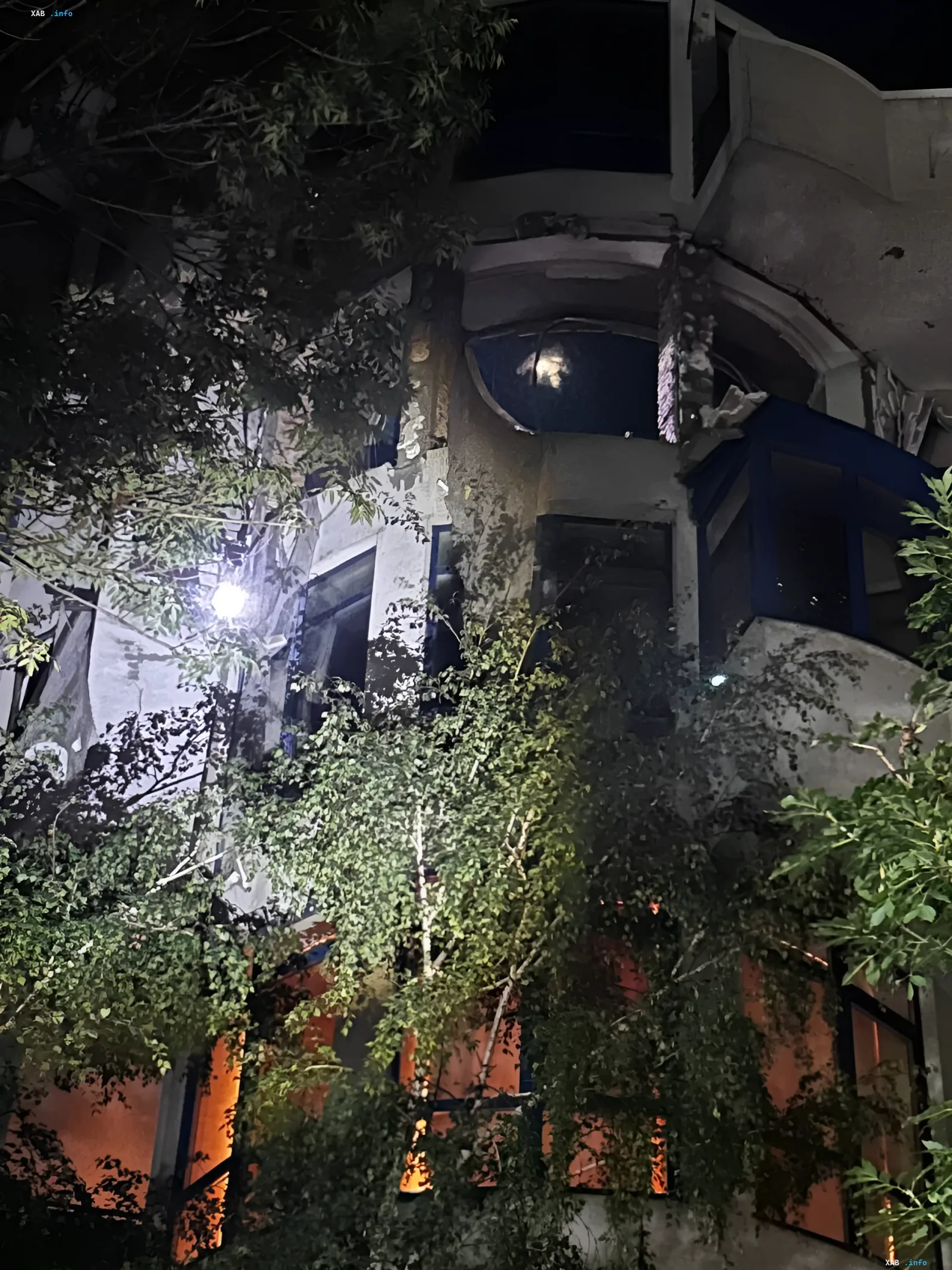 Damaged five-story building in Odesa after drone strike: night view of facade destruction