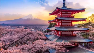Panoramic view of Mount Fuji and the red Chuen-ji pagoda in Kawasaki, surrounded by blooming cherry blossoms at sunset, symbolizing Japan's cultural heritage in the context of the fight against piracy.
