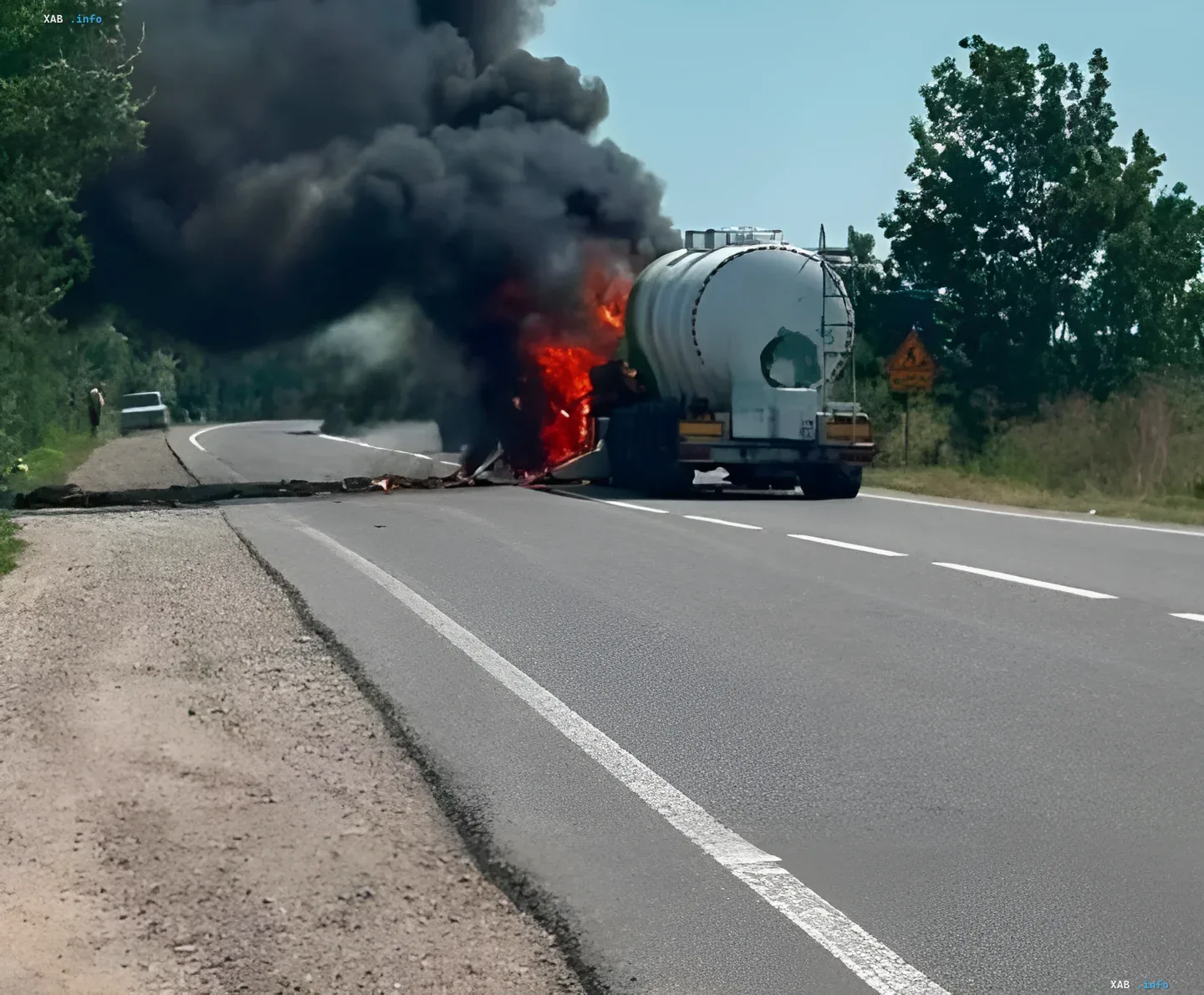 Aftermath of a strike on a tanker truck in Odesa region Burning tanker truck on a road in Odesa region after being hit, flames and thick black smoke visible