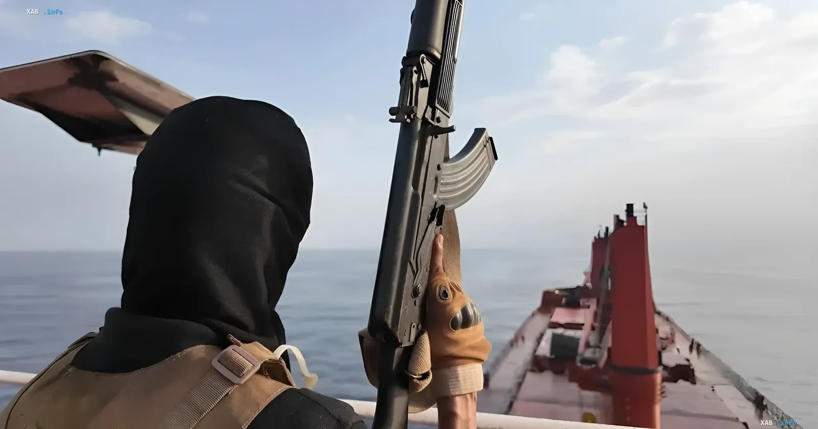 Fighter in black balaclava with AK-47 on board of a ship in the Red Sea — symbol of Houthi threat, against which Saudi Arabia formed a naval coalition
