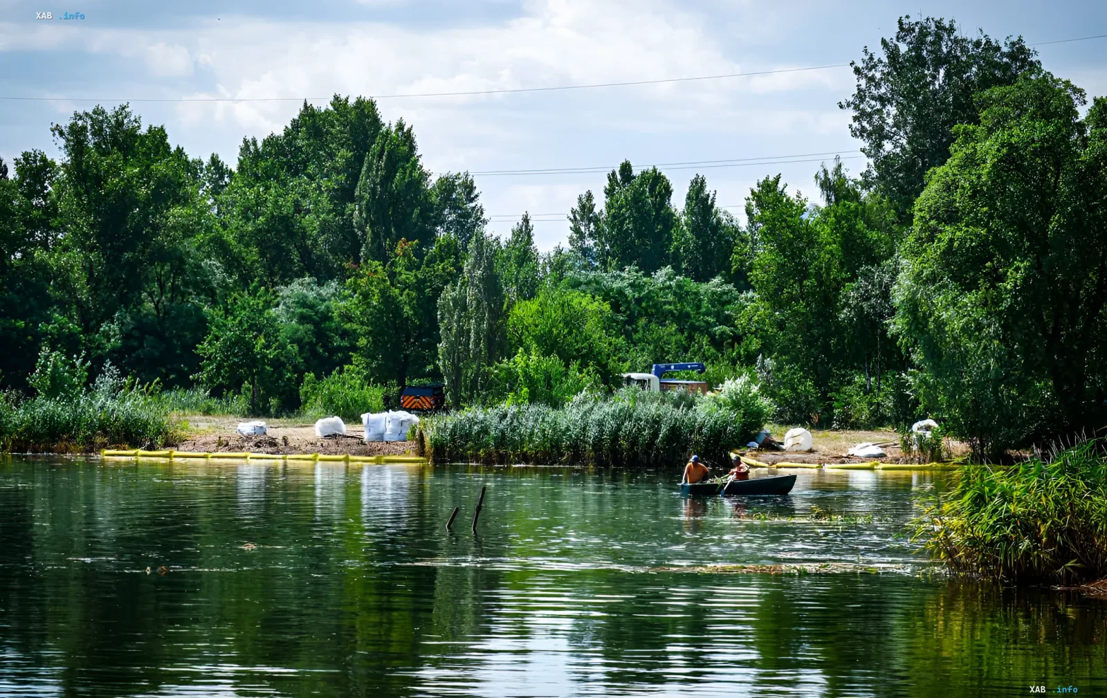 Arbeiter auf einem Boot reinigen den Fluss Irpin nach einer ökologischen Katastrophe, die zum Massensterben von Fischen führte