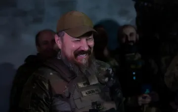 Командир украинских Сил специальных операций в камуфляже и берете, улыбающийся на фоне других бойцов, символизирующий успех операции «Крымский рубильник» по обесточиванию энергоузлов РФ