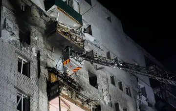 Fire truck ladder at damaged balcony of nine-story building in Smila after shrapnel drone strike