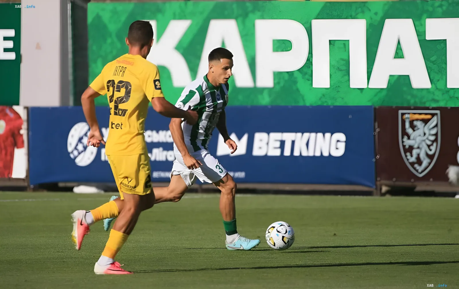 FK Karpaty player in white-green kit controls the ball under pressure from opponent in yellow during UPL match 2026/27 season