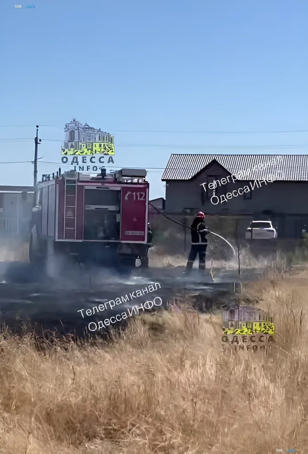 Firefighting in Nova Dofinovka: fire truck and rescuer at the scene of the blaze Firefighters extinguish a large fire in Nova Dofinovka near Odesa, where flames threaten residential houses