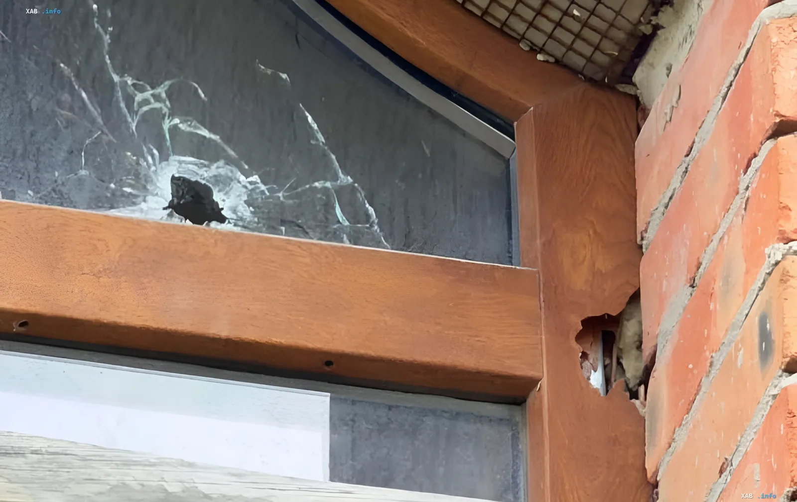 Shattered window of the UGCC cathedral in Kharkiv after a Russian strike, showing glass shards and damaged wooden frame