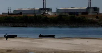 Paks Nuclear Power Plant with barges on the river used to control water levels during drought conditions
