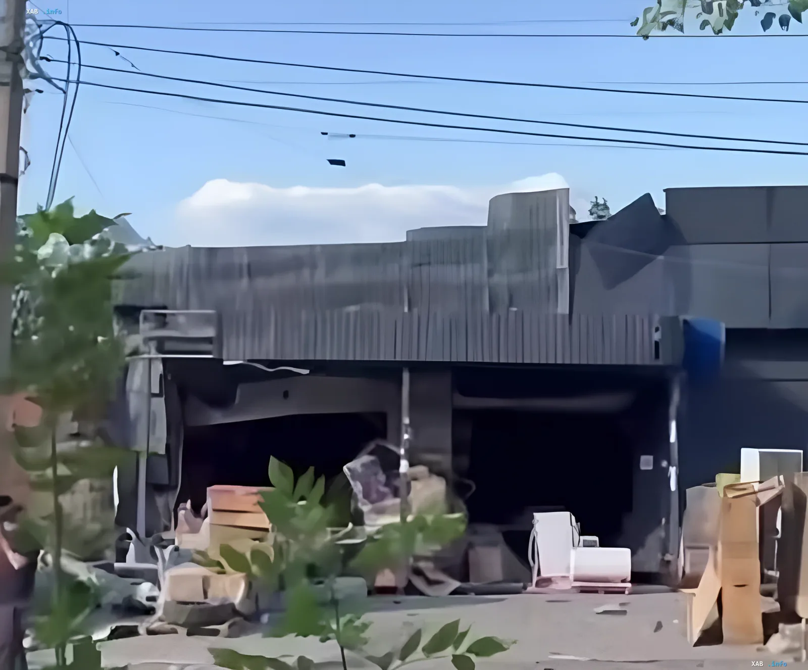 Destroyed New Post warehouse complex in Kramatorsk after Russian airstrike: damaged building with debris and boxes against the sky