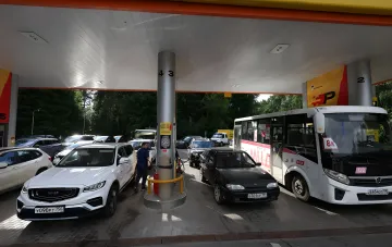 Длинная очередь из автомобилей и автобусов на заправке в России, иллюстрирующая топливный коллапс и дефицит бензина после удара по НПЗ
